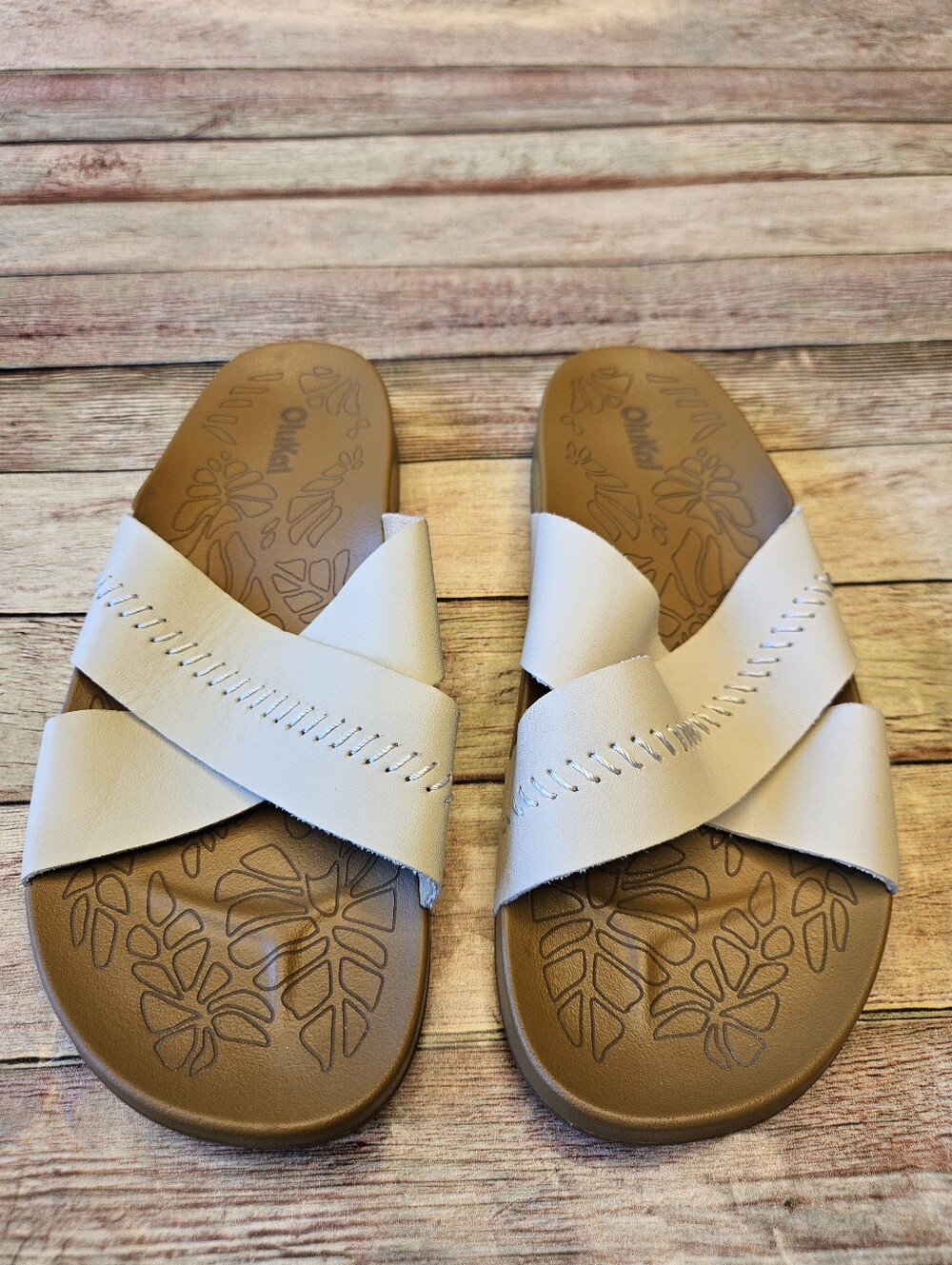 OluKai Kipe'a 'Olu women's slide sandals in the Puka/Tan colorway